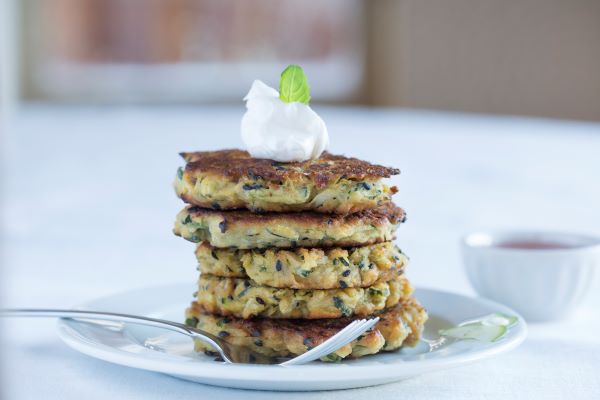 Curried Zucchini Fritters topped with WayFare Dairy Free Sour Cream.