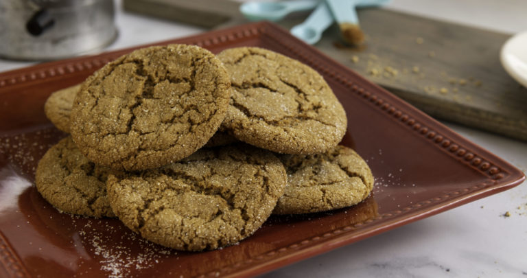Ginger cookies made with WayFare Dairy Free Butter Salted & Whipped are sitting on a red plate ready to be consumed.