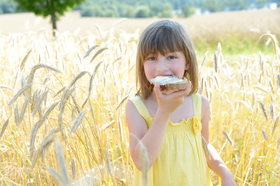 Child eating bread with dairy free butter substitute